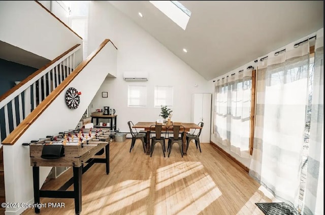 dining space with a wall mounted air conditioner, plenty of natural light, light wood finished floors, and stairs