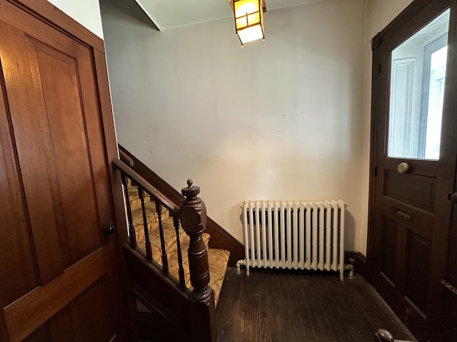 846 Thomas St, Stroudsburg, PA 18360 - foyer featuring radiator heating unit, dark wood-type flooring, and stairs