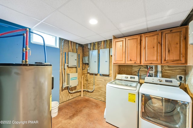 laundry area featuring gas water heater, washing machine and dryer, cabinet space, and electric panel