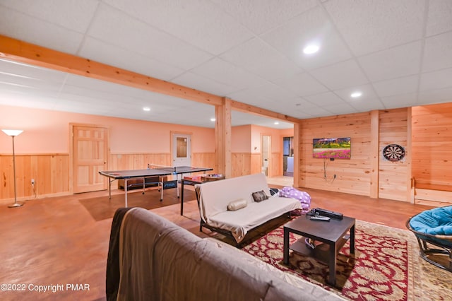 living room with a paneled ceiling, wainscoting, wood walls, and recessed lighting