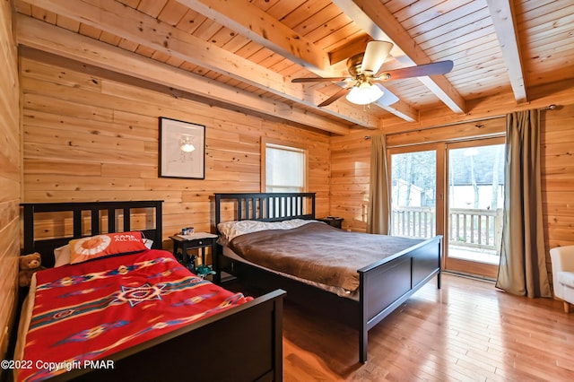 bedroom with access to exterior, wood ceiling, wooden walls, and beamed ceiling