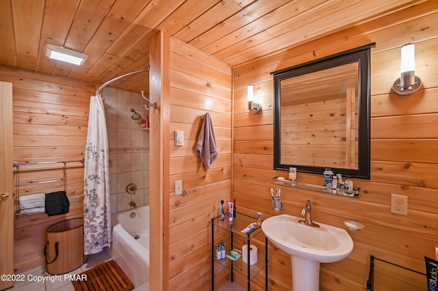 full bathroom featuring shower / bath combo, wood walls, wooden ceiling, and a sink