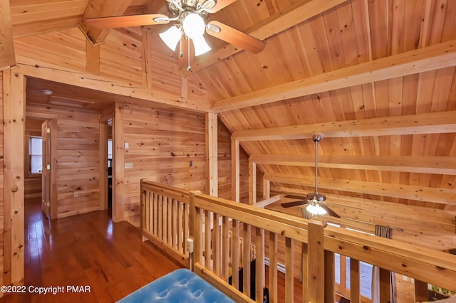 corridor with lofted ceiling with beams, wooden walls, wood finished floors, wood ceiling, and a sauna