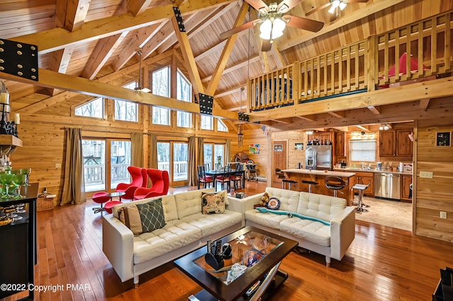 living area featuring wooden ceiling, wood walls, and light wood-type flooring