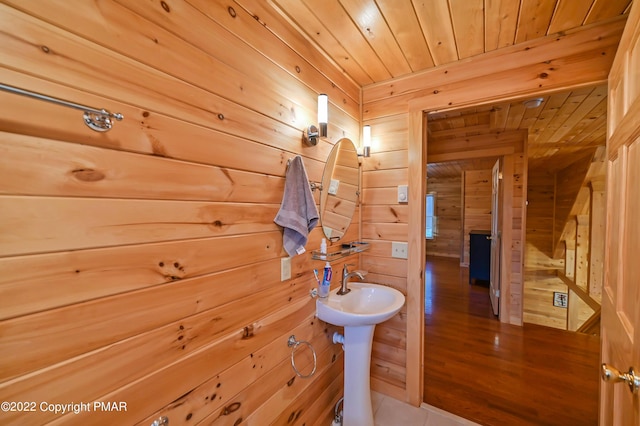 bathroom featuring wood walls and wood ceiling