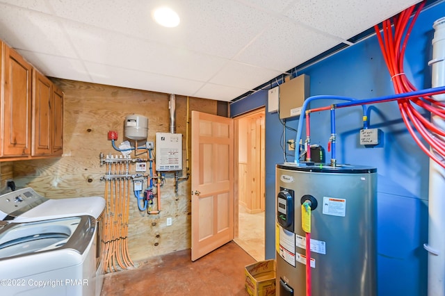 washroom with cabinet space, washing machine and clothes dryer, and electric water heater