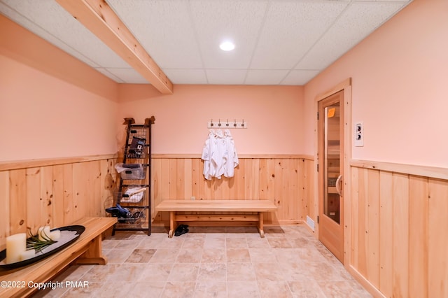 mudroom with a drop ceiling and wainscoting