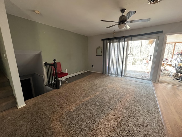 living area with carpet flooring, a ceiling fan, visible vents, and a baseboard radiator