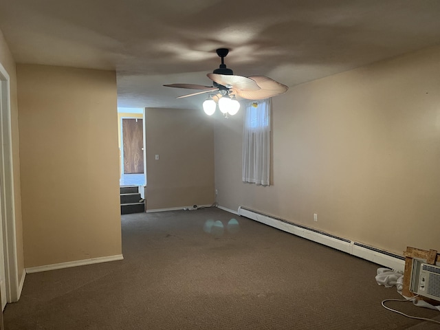 spare room with a ceiling fan, dark colored carpet, baseboard heating, and baseboards