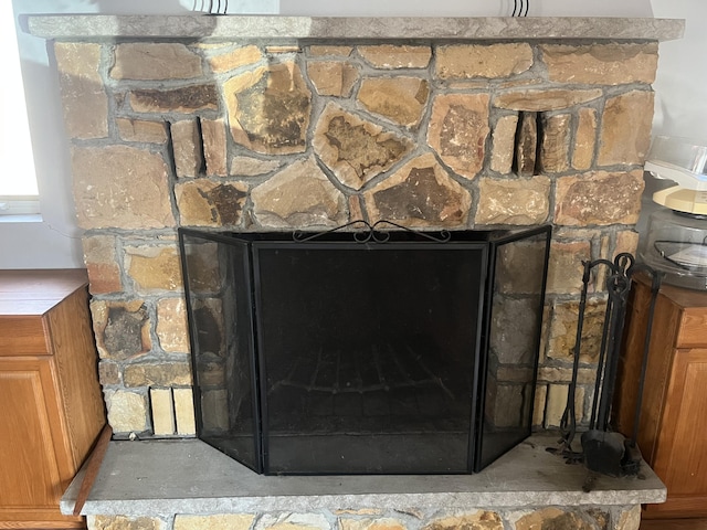 interior details featuring a fireplace with raised hearth