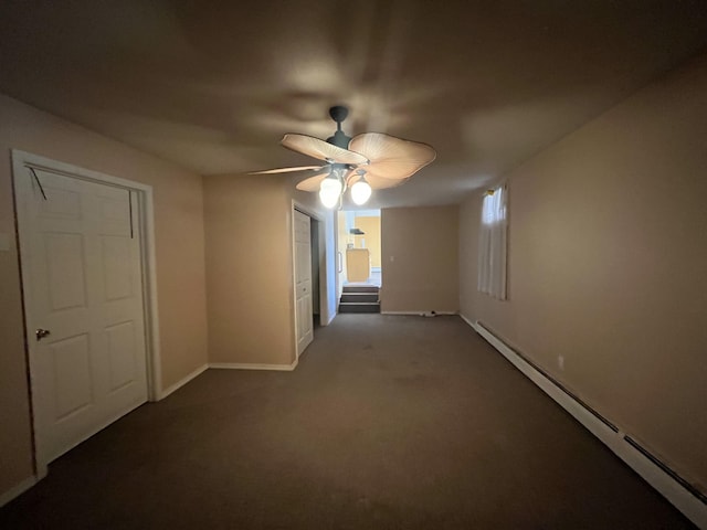 carpeted spare room with baseboards, baseboard heating, and ceiling fan