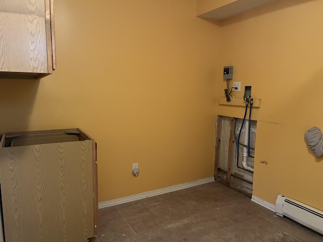 washroom featuring baseboard heating, cabinet space, hookup for a washing machine, and baseboards