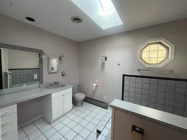 full bath with visible vents, toilet, baseboard heating, a skylight, and vanity