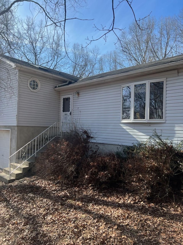 view of exterior entry with a garage