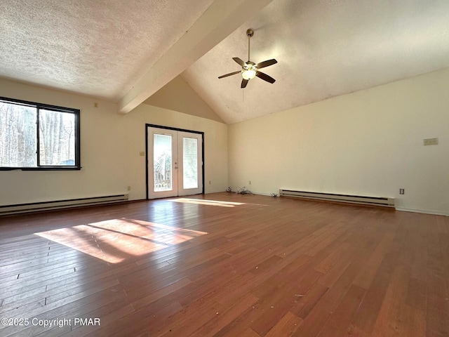 empty room with hardwood / wood-style flooring, a baseboard radiator, and a wealth of natural light