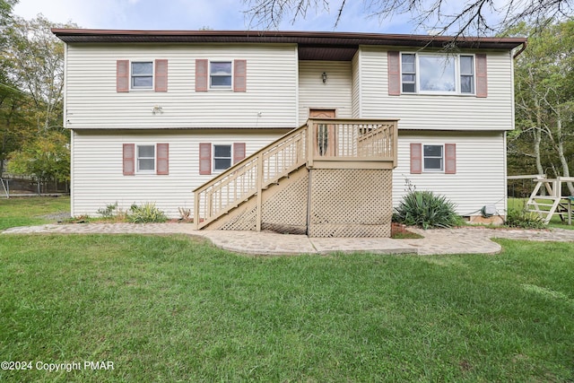 back of house featuring a yard and stairway