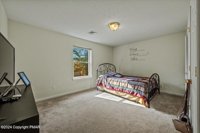 carpeted bedroom featuring visible vents and baseboards