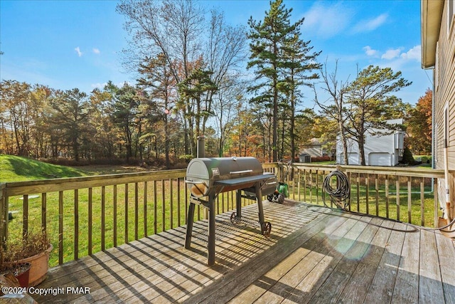 wooden terrace with a yard and area for grilling