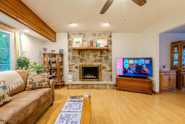 113 Larsen Ln, Cresco, PA 18326 - living room featuring wood finished floors, a ceiling fan, and a stone fireplace