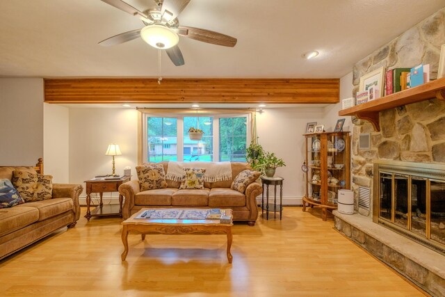 113 Larsen Ln, Cresco, PA 18326 - living room with a ceiling fan, light wood finished floors, a fireplace, beamed ceiling, and a baseboard radiator