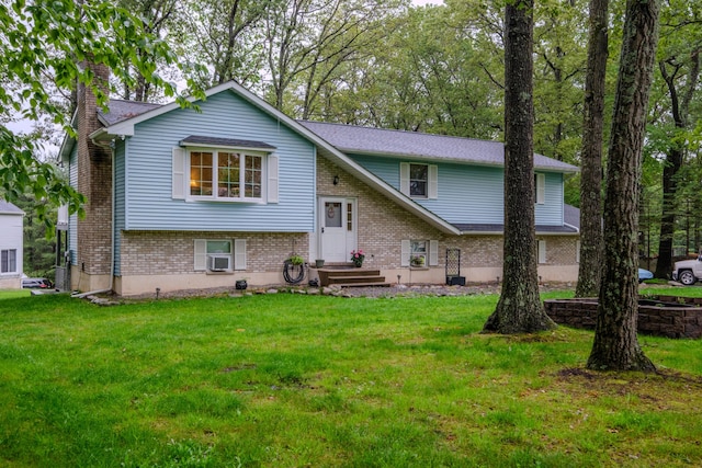 113 Larsen Ln, Cresco, PA 18326 - raised ranch with brick siding, a front yard, and a chimney