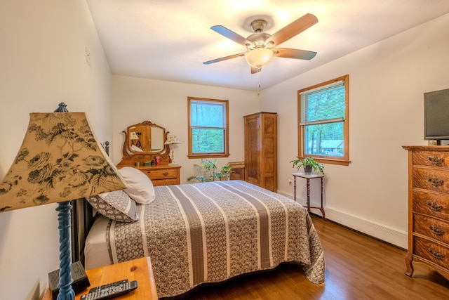 113 Larsen Ln, Cresco, PA 18326 - bedroom featuring baseboard heating, wood finished floors, and a ceiling fan