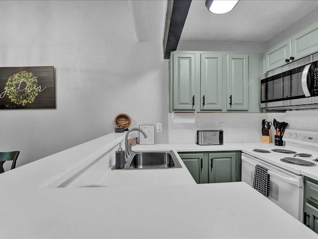 216 Snow Ridge Cir, Lake Harmony, PA 18624 - kitchen with stainless steel microwave, white electric range, green cabinetry, a sink, and tasteful backsplash
