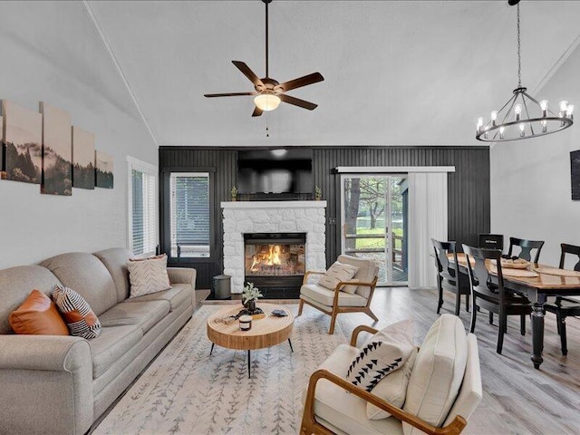 216 Snow Ridge Cir, Lake Harmony, PA 18624 - living area with a chandelier, a ceiling fan, light wood-type flooring, a fireplace, and high vaulted ceiling