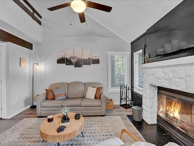 216 Snow Ridge Cir, Lake Harmony, PA 18624 - living area featuring a stone fireplace, a ceiling fan, baseboards, and high vaulted ceiling