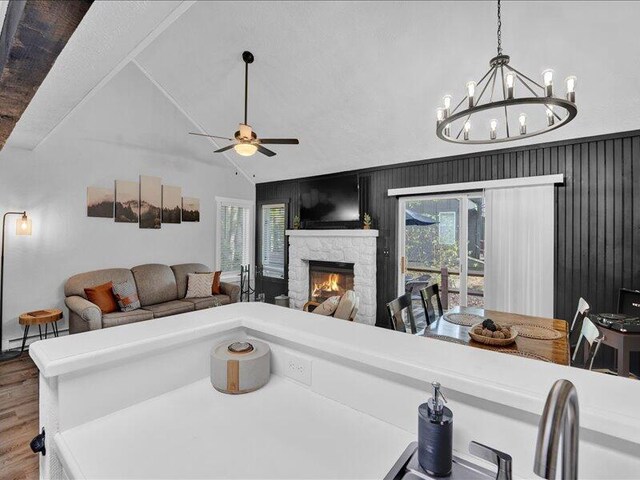 216 Snow Ridge Cir, Lake Harmony, PA 18624 - living area with plenty of natural light, wood finished floors, a fireplace, lofted ceiling, and a ceiling fan