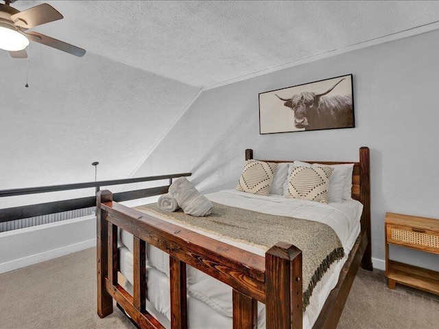 216 Snow Ridge Cir, Lake Harmony, PA 18624 - bedroom featuring vaulted ceiling, a textured ceiling, light colored carpet, baseboards, and a ceiling fan