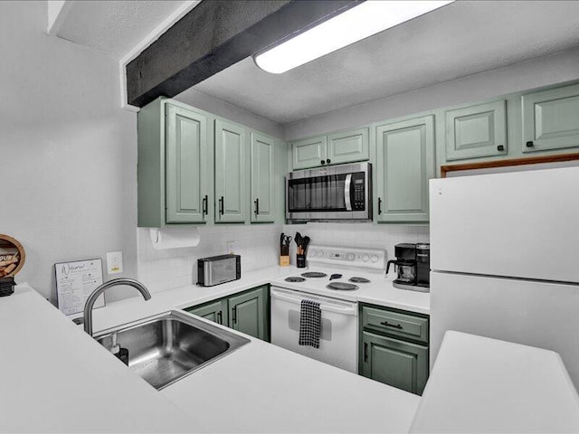 216 Snow Ridge Cir, Lake Harmony, PA 18624 - kitchen with white appliances, green cabinetry, a sink, decorative backsplash, and light countertops