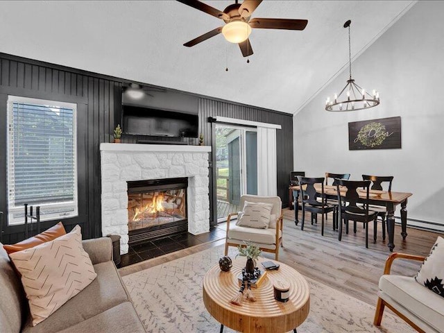 216 Snow Ridge Cir, Lake Harmony, PA 18624 - living area featuring plenty of natural light, lofted ceiling, a stone fireplace, wood finished floors, and ceiling fan