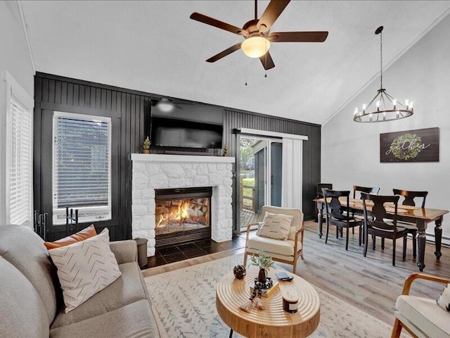 216 Snow Ridge Cir, Lake Harmony, PA 18624 - living room with vaulted ceiling, plenty of natural light, ceiling fan, wood finished floors, and a fireplace