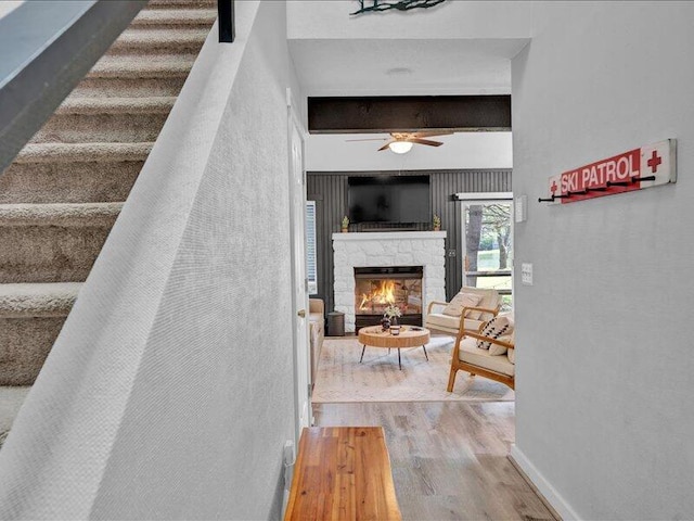 216 Snow Ridge Cir, Lake Harmony, PA 18624 - stairway featuring wood finished floors, ceiling fan, and a stone fireplace