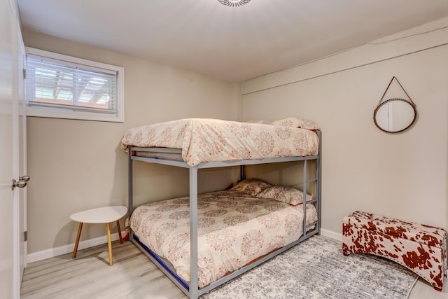 bedroom featuring baseboards and wood finished floors