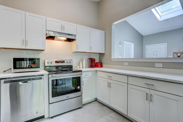 kitchen featuring light countertops, backsplash, appliances with stainless steel finishes, white cabinetry, and under cabinet range hood