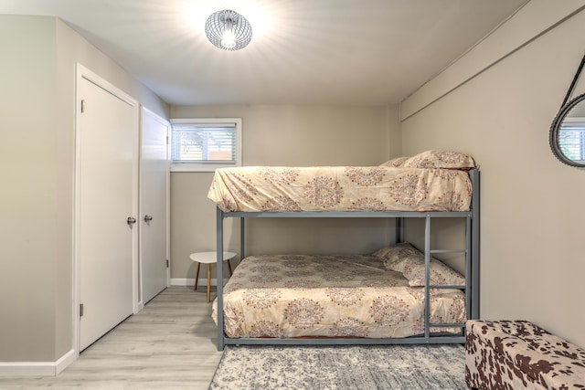 bedroom featuring light wood-type flooring and baseboards