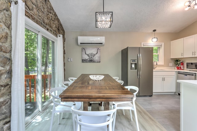 dining area with a textured ceiling and an AC wall unit