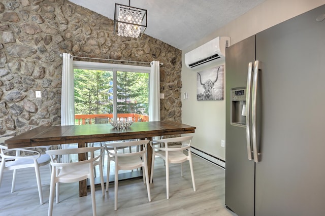 dining room with a baseboard radiator, light wood-style flooring, an AC wall unit, vaulted ceiling, and a textured ceiling