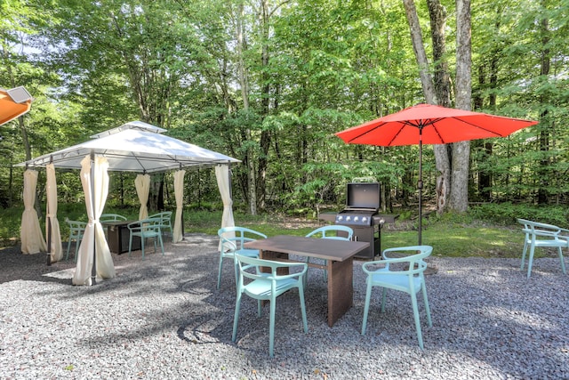 view of patio / terrace featuring outdoor dining space and a gazebo