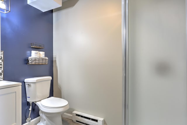 bathroom featuring baseboard heating, vanity, and toilet