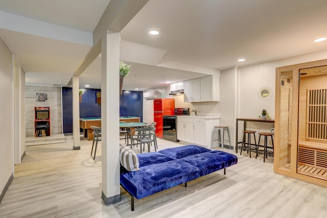 interior space featuring recessed lighting, light wood-style flooring, and baseboards