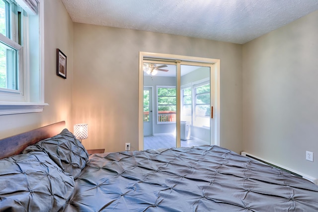 unfurnished bedroom with a textured ceiling and a baseboard radiator