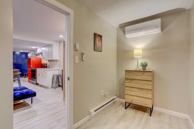 hall featuring light wood-style floors, a baseboard radiator, baseboards, and a wall mounted AC