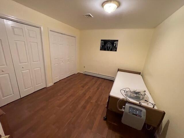 115 Murphy Ln, Kunkletown, PA 18058 - unfurnished bedroom with baseboard heating, multiple closets, and dark wood-style floors