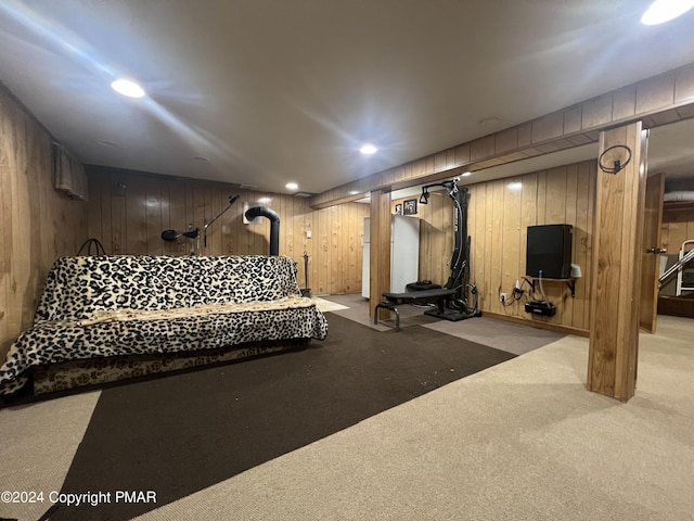 exercise room with wooden walls, recessed lighting, and carpet floors