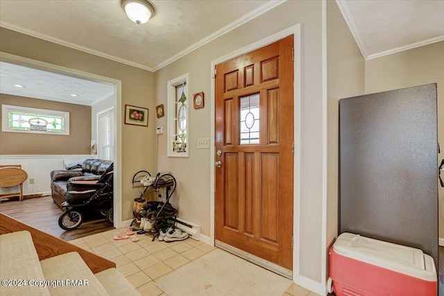 foyer entrance featuring baseboards, crown molding, and light tile patterned flooring