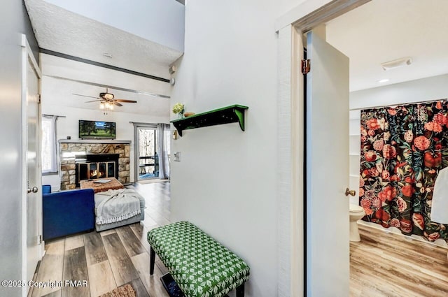 hallway with hardwood / wood-style floors and beam ceiling