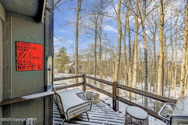 view of snow covered back of property